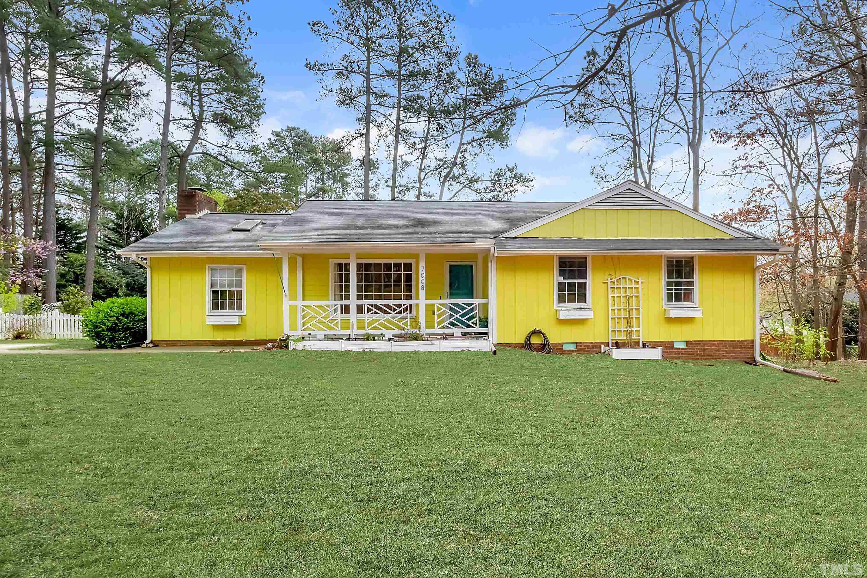 7008 Ray Road Raleigh, NC 27613 - Photo 1 of 36 a front view of a house with a garden