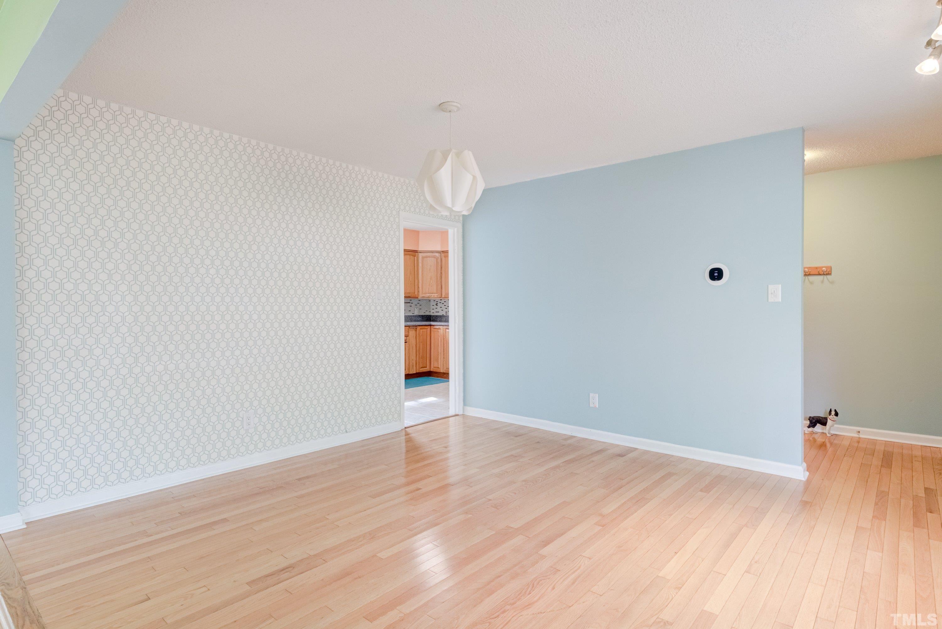 7008 Ray Road Raleigh, NC 27613 - Photo 12 of 36 a view of an empty room with wooden floor