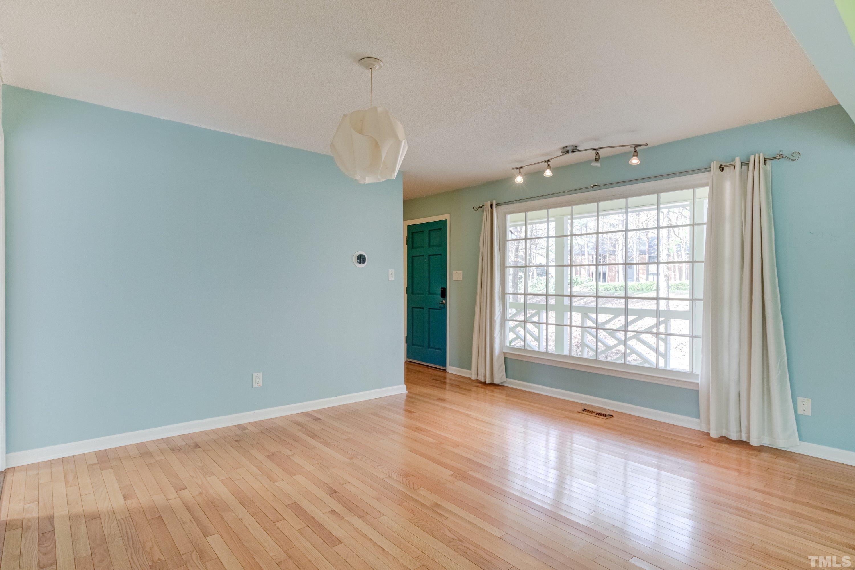 7008 Ray Road Raleigh, NC 27613 - Photo 13 of 36 a view of an empty room with wooden floor and a window