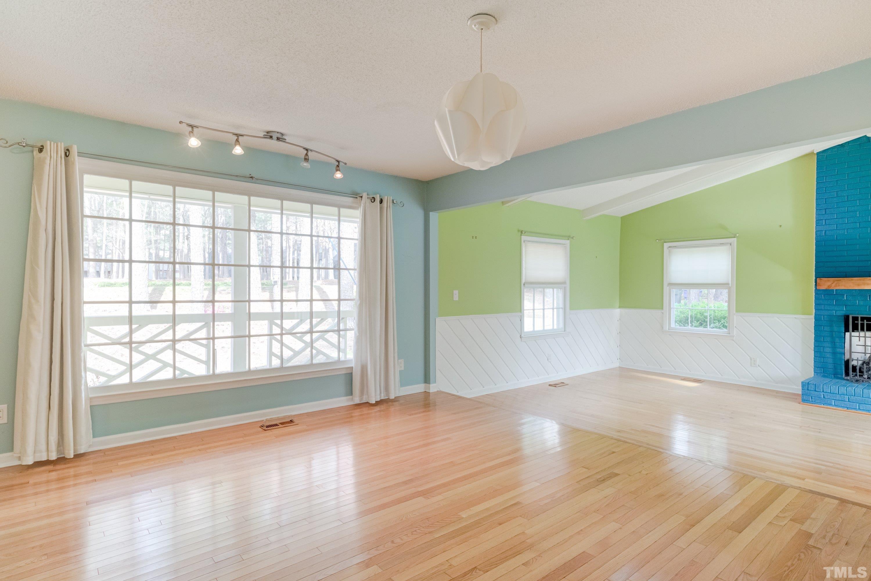 7008 Ray Road Raleigh, NC 27613 - Photo 14 of 36 an empty room with wooden floor and windows