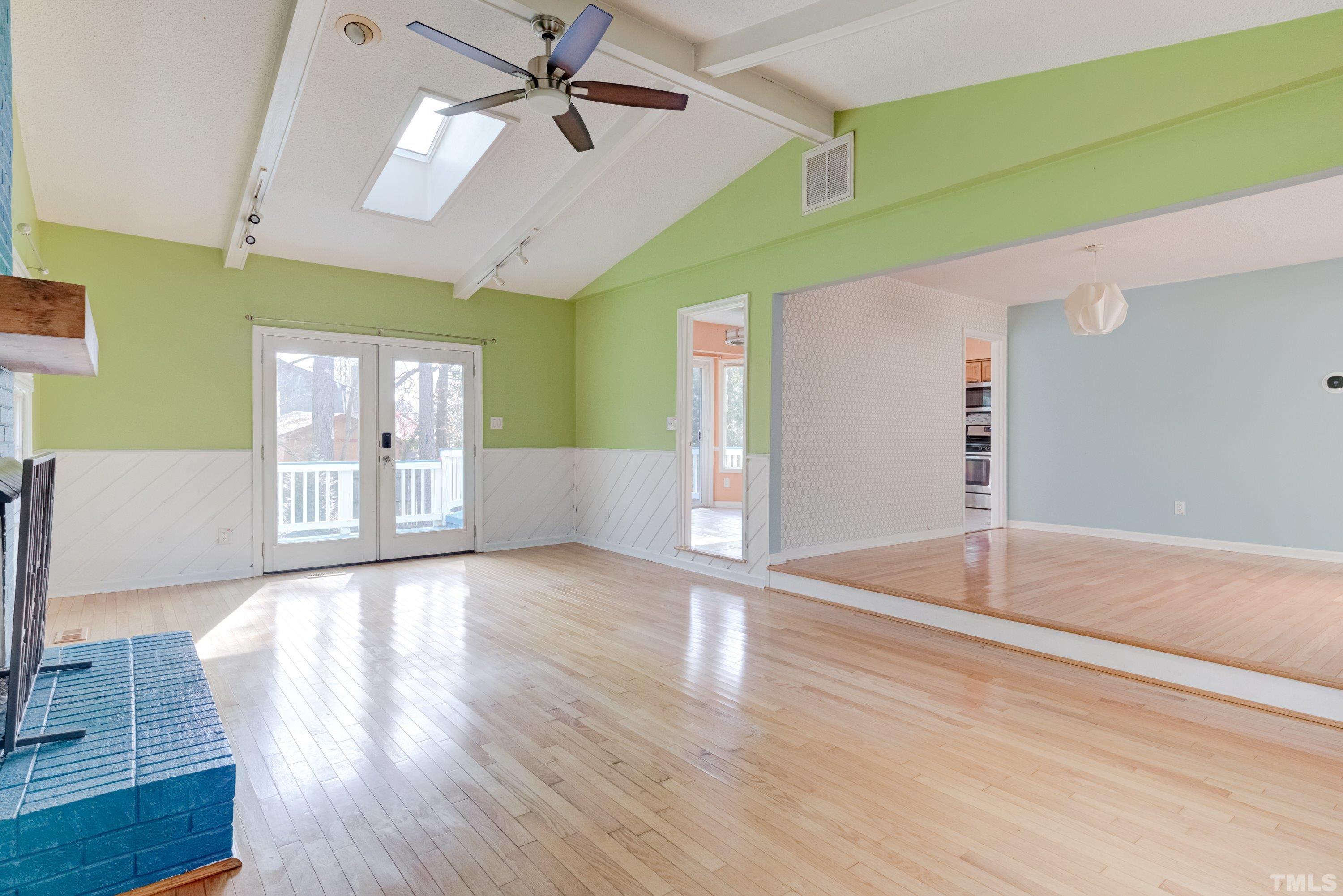 7008 Ray Road Raleigh, NC 27613 - Photo 17 of 36 a view of a livingroom with wooden floor and a ceiling fan