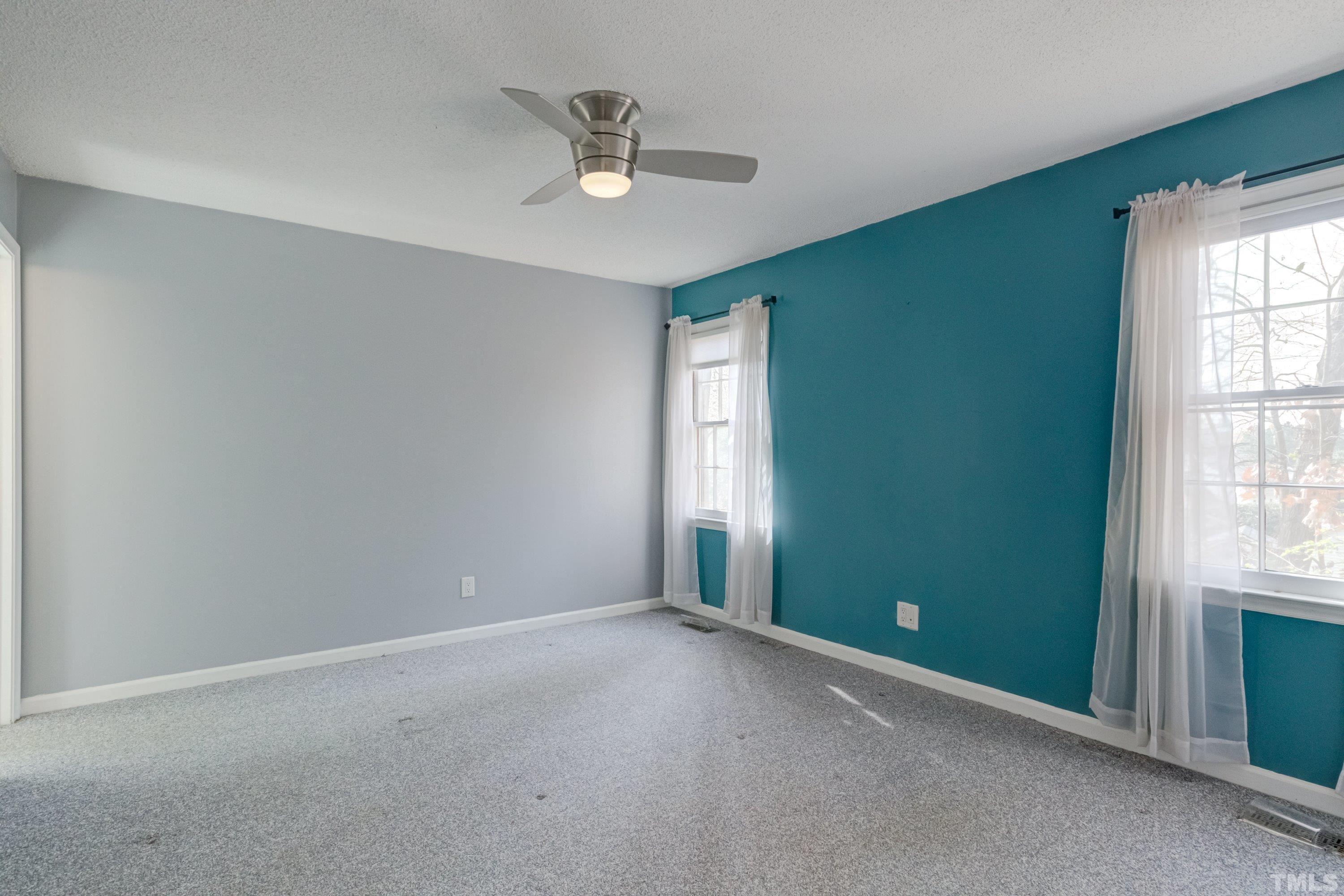 7008 Ray Road Raleigh, NC 27613 - Photo 20 of 36 an empty room with windows and fan
