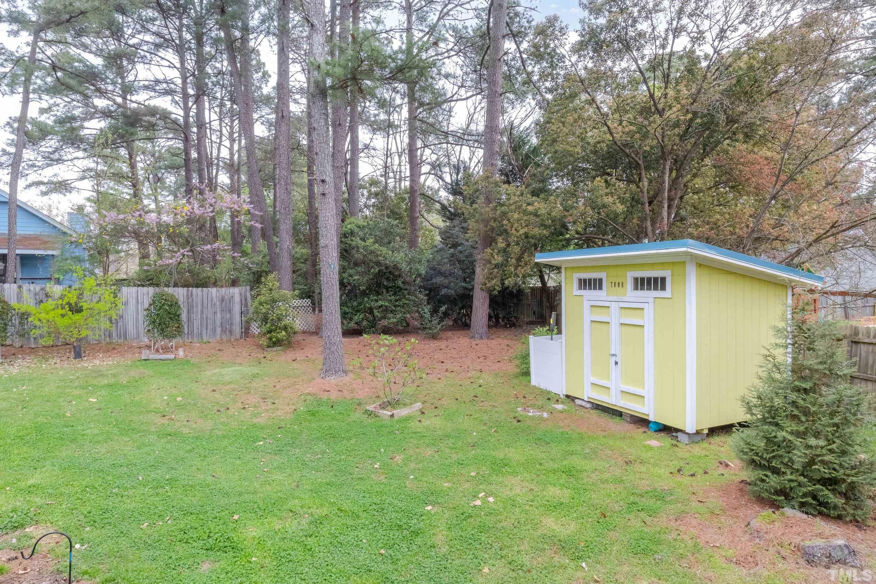 7008 Ray Road Raleigh, NC 27613 - Photo 34 of 36 a front view of house with yard and trees in the background