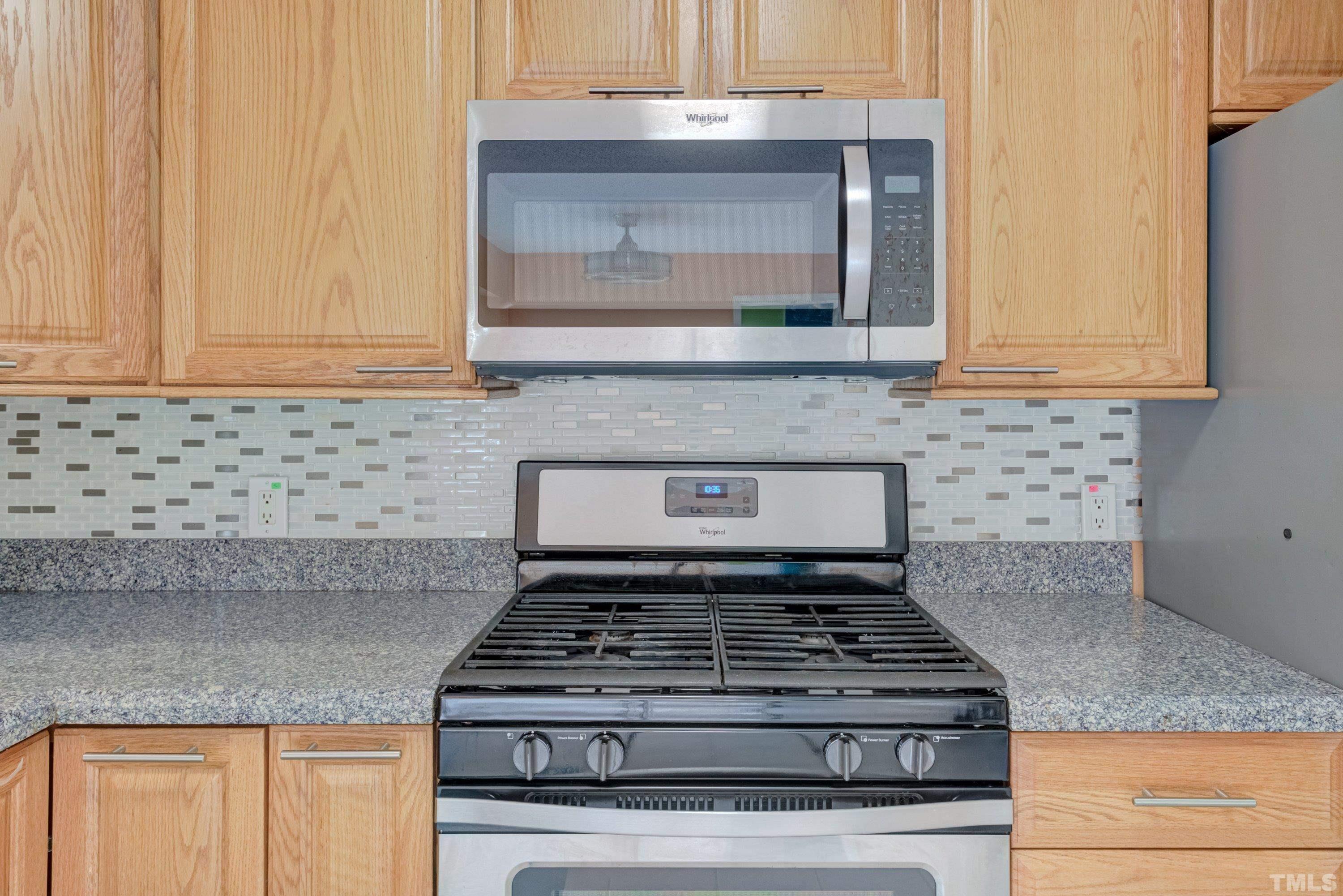 7008 Ray Road Raleigh, NC 27613 - Photo 5 of 36 a stove top oven sitting inside of a kitchen
