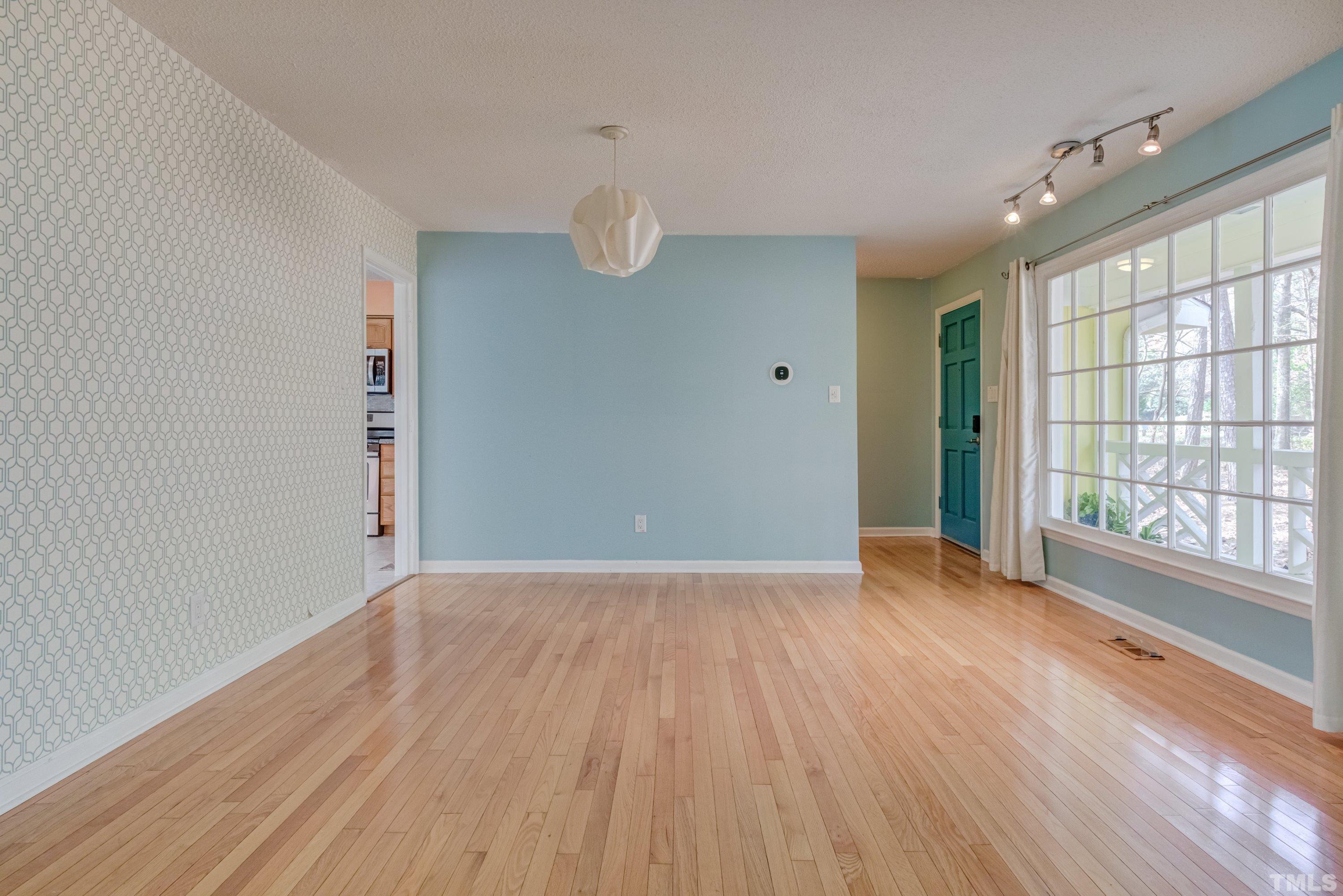 7008 Ray Road Raleigh, NC 27613 - Photo 10 of 36 wooden floor in an empty room with a window