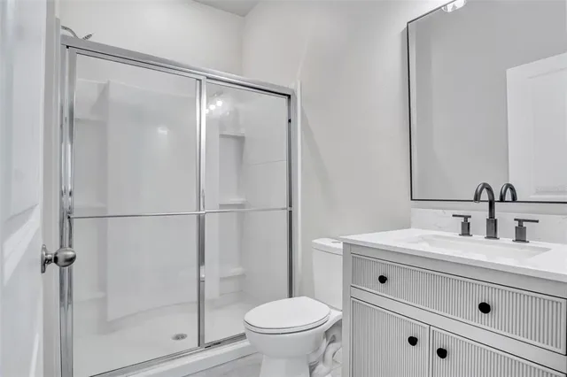 a bathroom with a sink toilet and shower