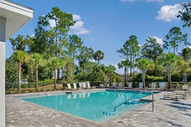 swimming pool view with a seating space