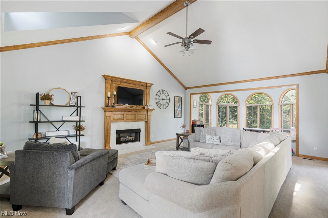 939 Pontius Road Mogadore, OH 44260 - Photo 8 of 35 Carpeted living room with vaulted ceiling high, ceiling fan, and beamed ceiling