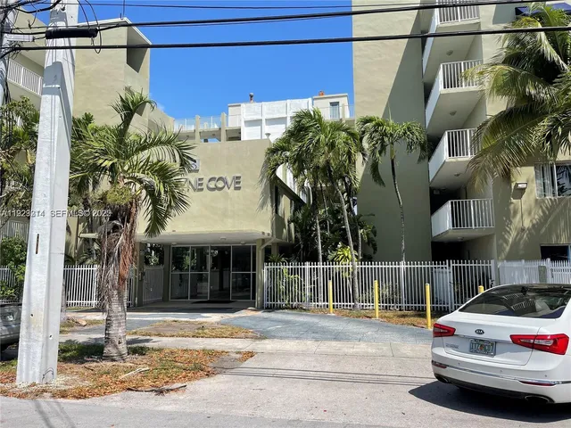 a view of a building with car parked