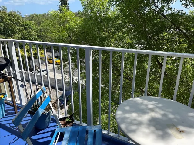 a view of a balcony with wooden floor