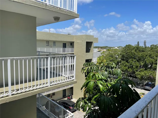a roof deck with table and chairs