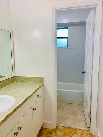 a bathroom with a tub and shower