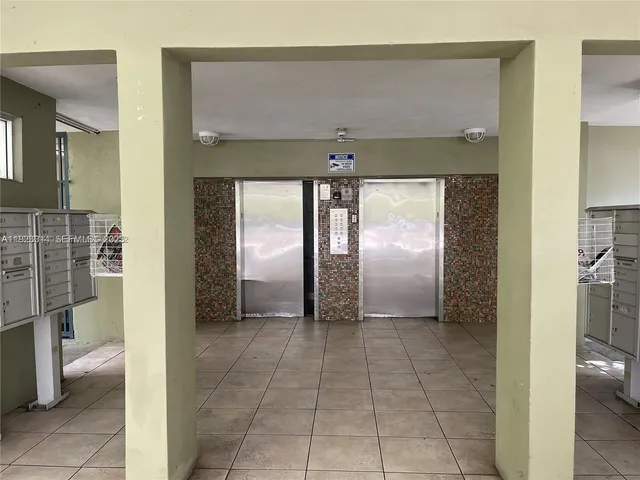 a view of a hallway with a bathroom