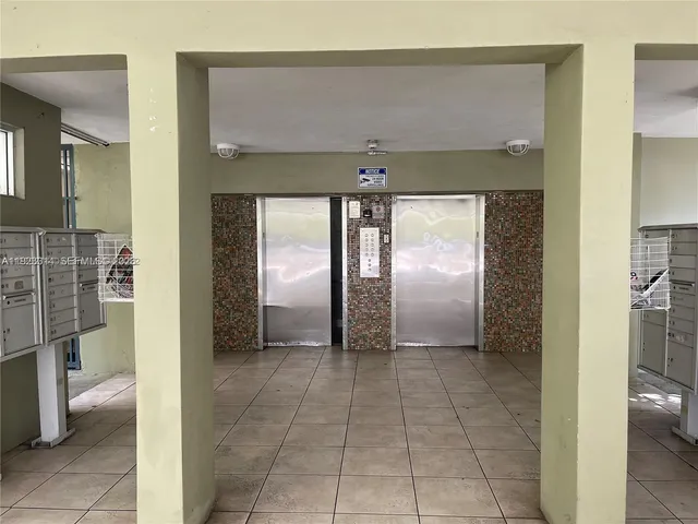 a view of a hallway with a bathroom