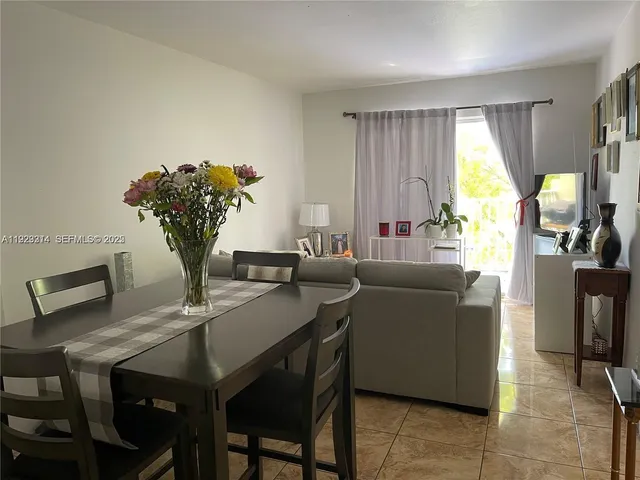 a living room with furniture a chandelier and a window