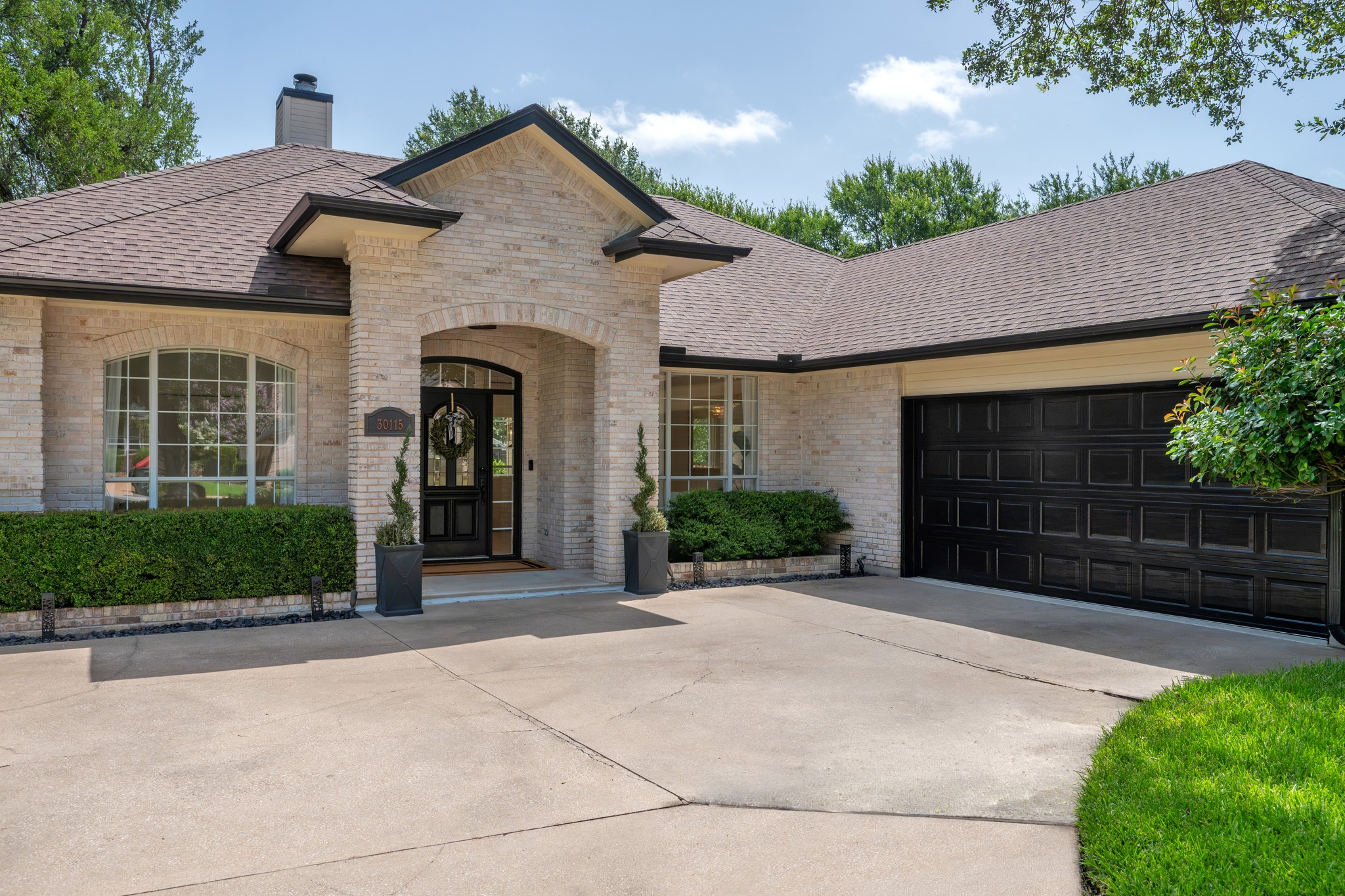 30115 Sawgrass Trail Georgetown, TX 78628 - Photo 25 of 37 A classic brick exterior with a welcoming arched entryway and spacious attached garage.