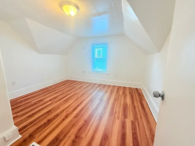 a view of a room with wooden floor and window