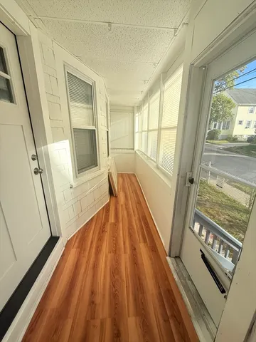 a view of an entryway with wooden floor