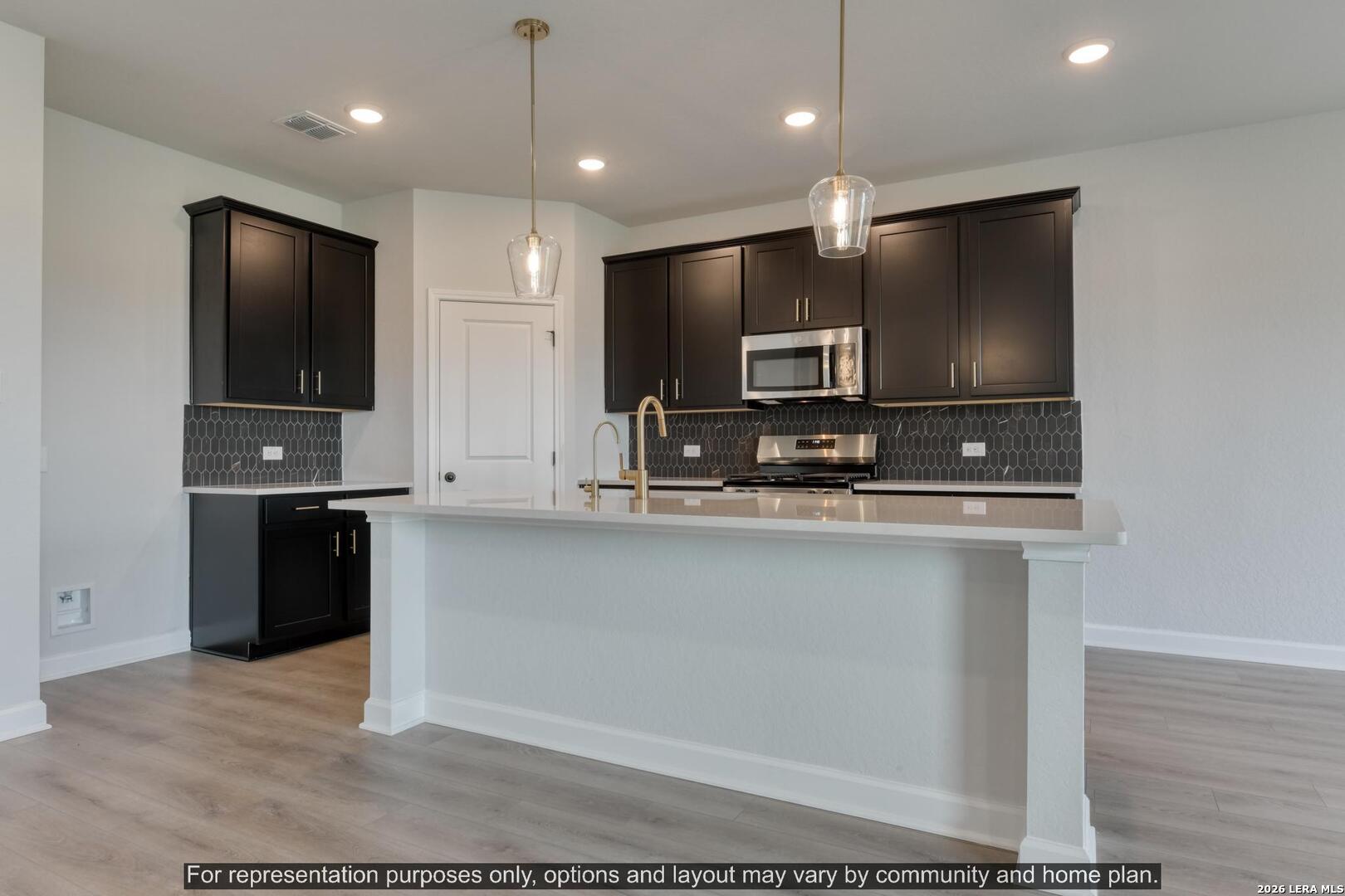 145 Yale Street Seguin, TX 78155 - Photo 13 of 24 a view of kitchen with microwave and refrigerator