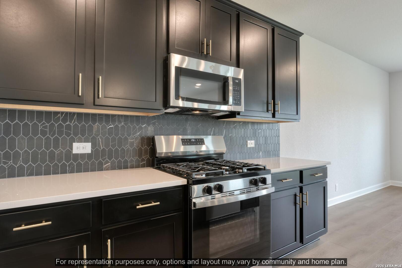 145 Yale Street Seguin, TX 78155 - Photo 14 of 24 a kitchen with a stove and a microwave