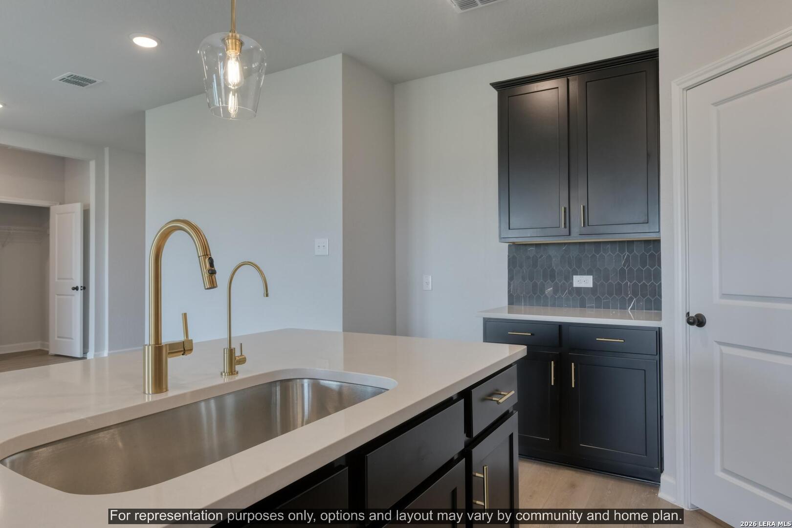 145 Yale Street Seguin, TX 78155 - Photo 15 of 24 a kitchen with a sink and chandelier