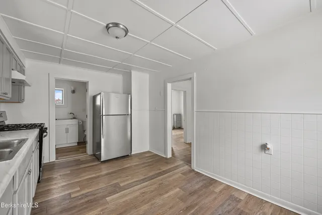 a view of a kitchen with a sink and a refrigerator