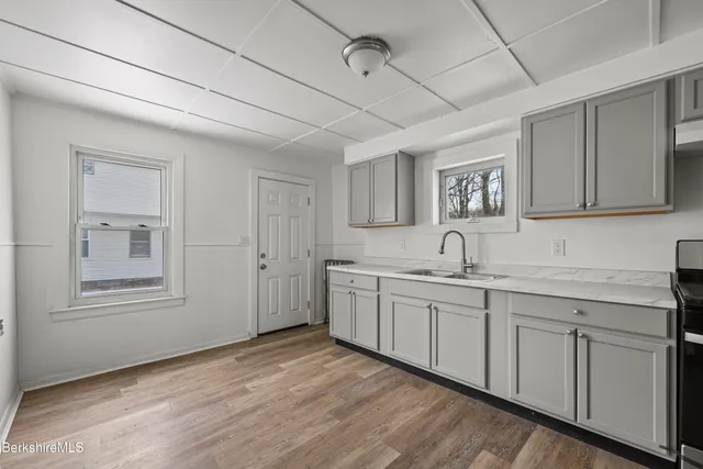 a view of a kitchen with sink and microwave