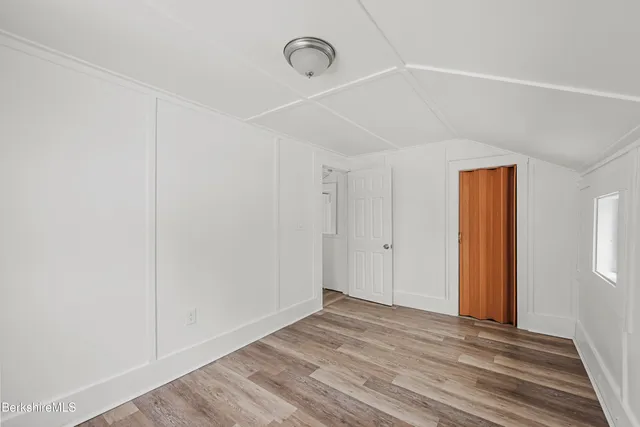 a view of a room with wooden floor