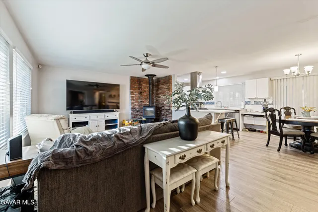 a living room with lots of furniture and kitchen view