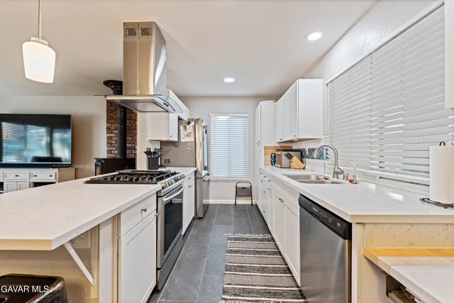 a large kitchen with a stove and a sink