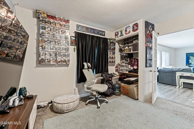 a view of a workspace with furniture and a window