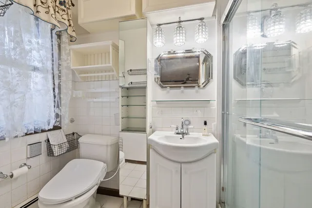 a bathroom with a sink toilet and mirror