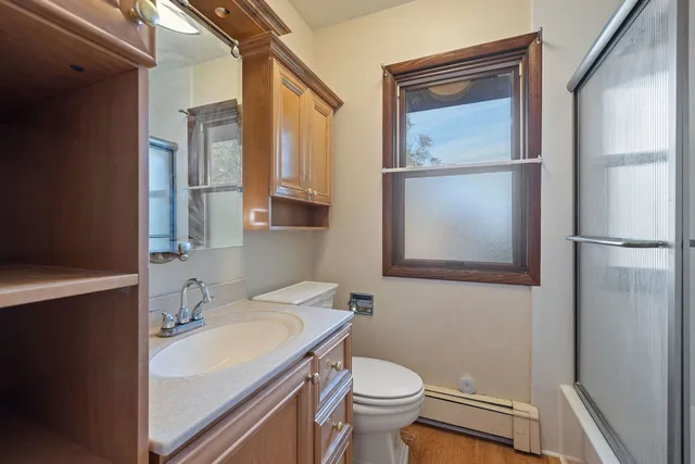 a bathroom with a sink a toilet and a mirror