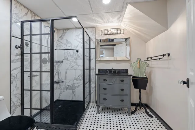 a bathroom with a shower and a sink