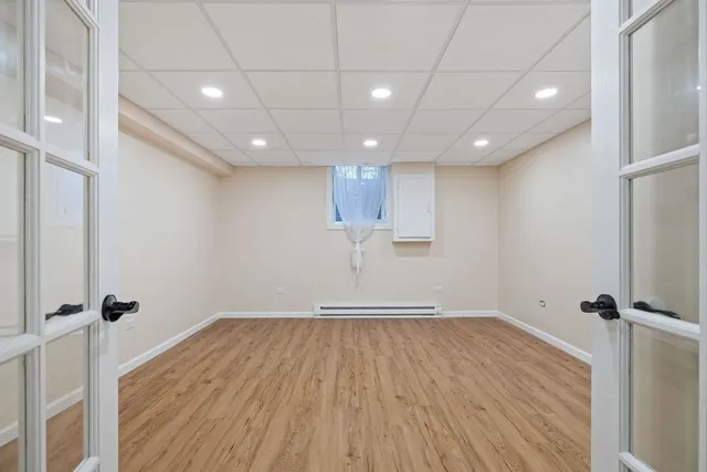 a view of empty room with wooden floor