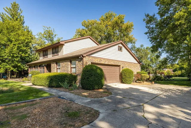 a front view of a house with a yard and outdoor seating