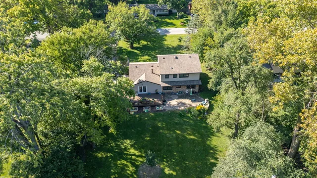 with aerial view of a house with a yard