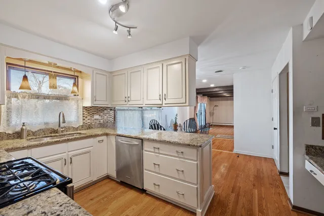 a kitchen with a stove a sink and a refrigerator