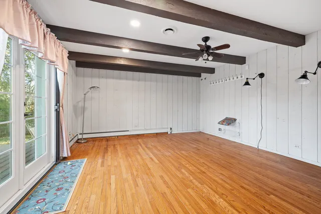 a view of a room with wooden floor