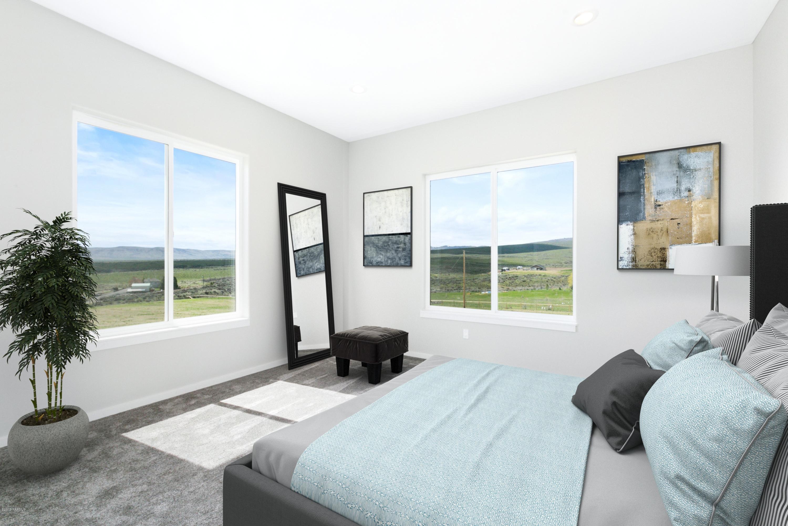 640 Winchester Road Yakima, WA 98908 - Photo 11 of 26 a bedroom with a bed and a large window
