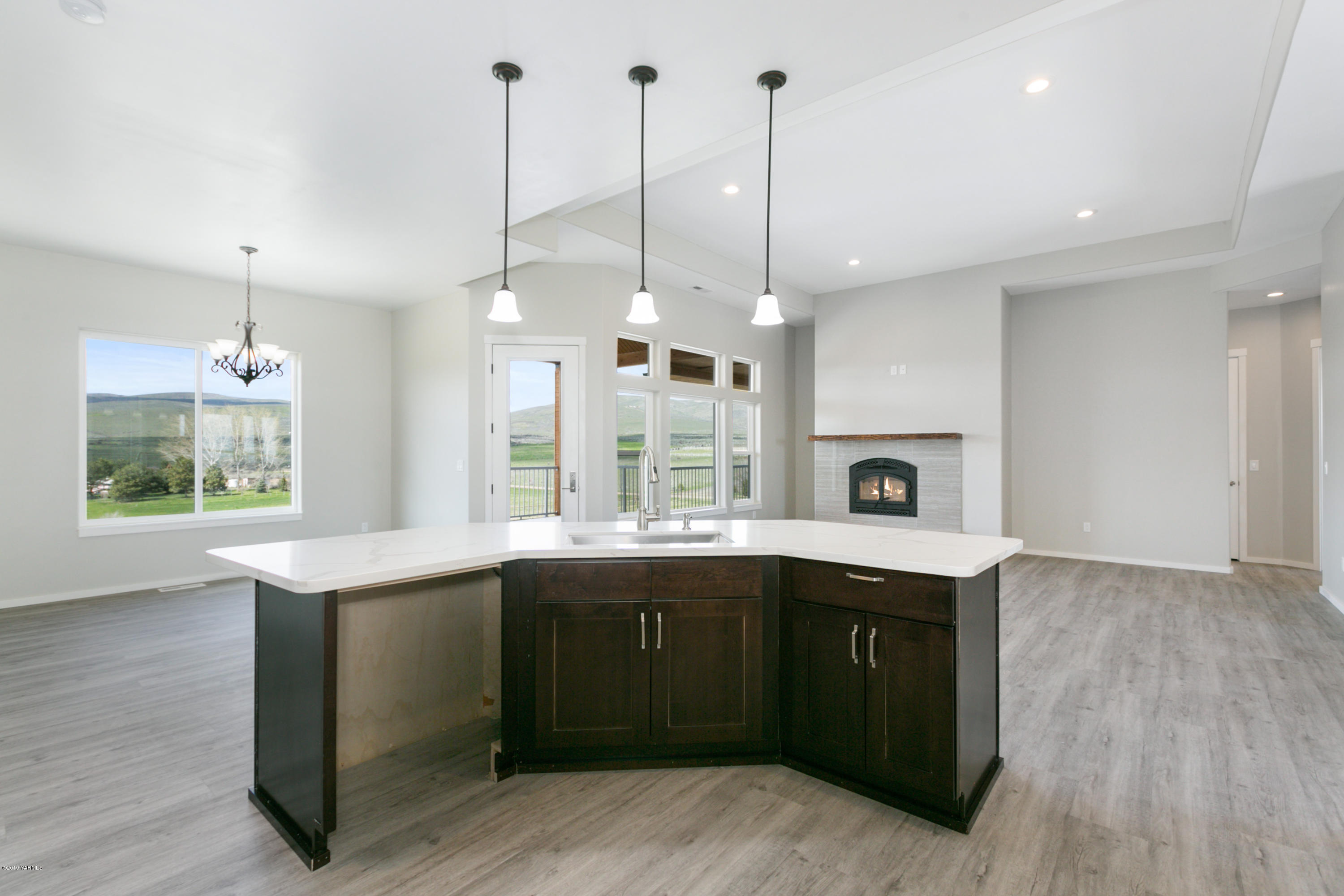 640 Winchester Road Yakima, WA 98908 - Photo 9 of 26 a kitchen with a sink a window and wooden floor