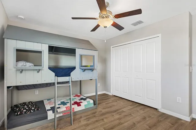 a bed sitting in a bedroom next to a window