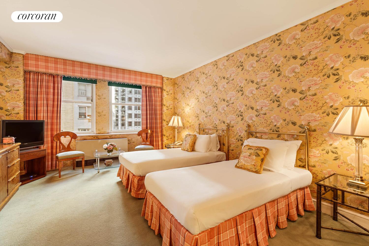 111 East 56th Street, Unit 1107 Manhattan, NY 10022 - Photo 3 of 6 a bedroom with a bed and wooden floor