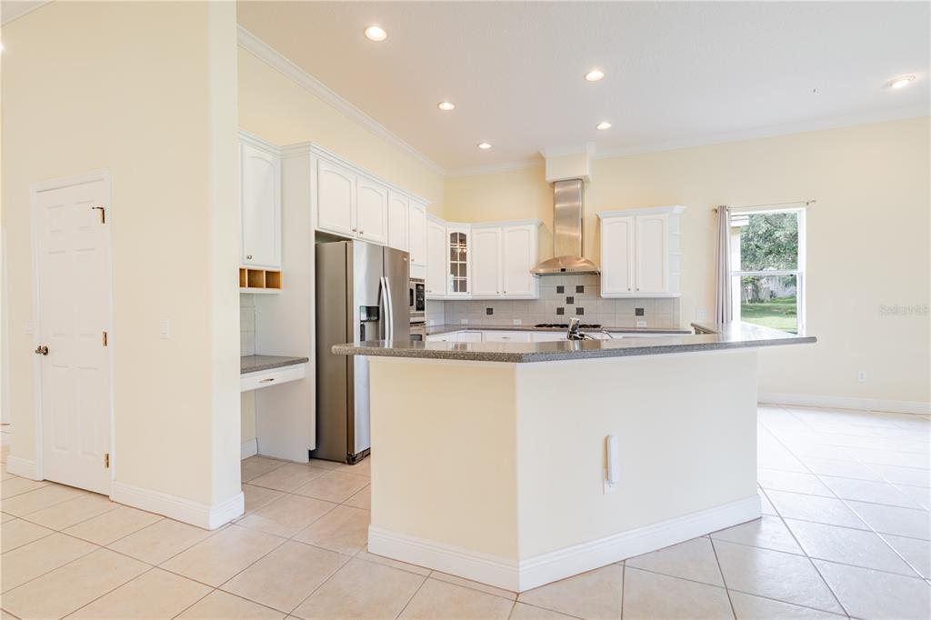 2718 Knightsbridge Road Clermont, FL 34711 - Photo 19 of 72 a kitchen with stainless steel appliances granite countertop a refrigerator and a sink
