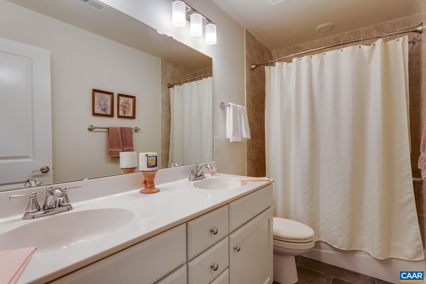 1927 Fowler Street Charlottesville, VA 22901 - Photo 30 of 36 a bathroom with a sink a toilet and a mirror