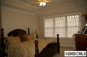 2044 Roadrunner Road Clover, SC 29710 - Photo 6 of 7 a bedroom with a bed and a chandelier