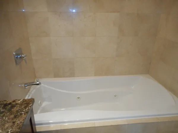 a bathroom with a granite countertop sink a toilet and a mirror