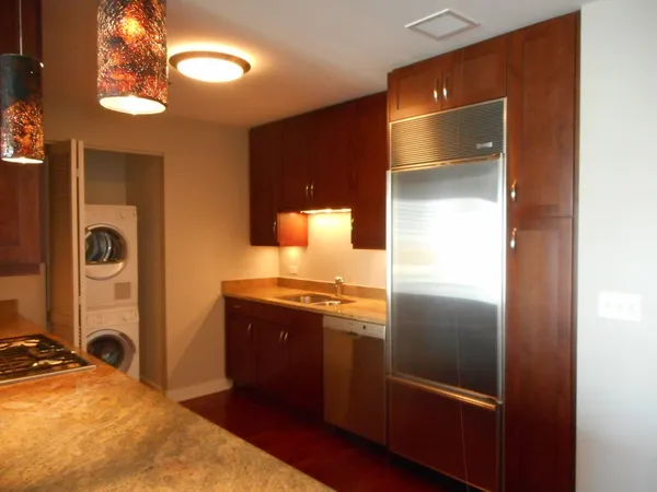 a kitchen with wooden cabinets and a stove top oven