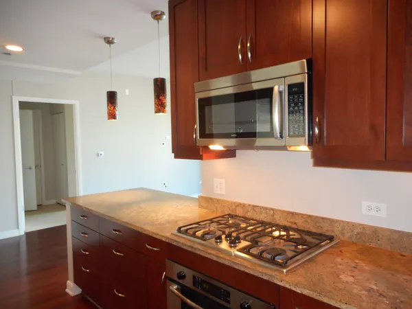 a kitchen with a refrigerator and cabinets