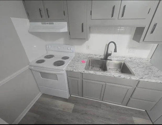 a utility room with sink dryer and washer